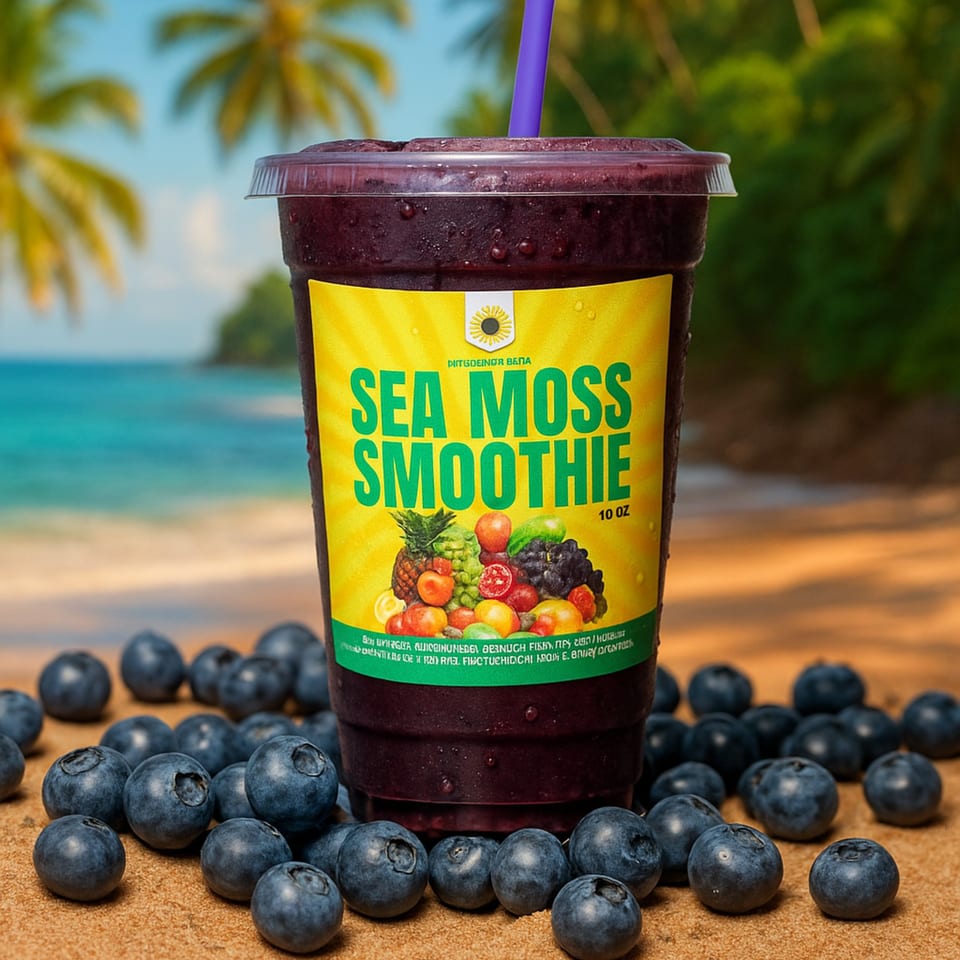 A Sea Moss Smoothie with a purple straw, surrounded by blueberries on a sandy beach.