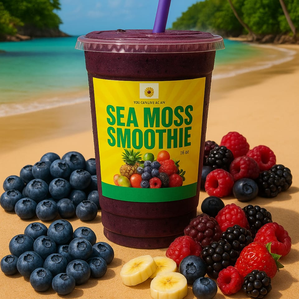 A You Can Live Again Sea Moss Smoothie with berries and banana slices on a beach.